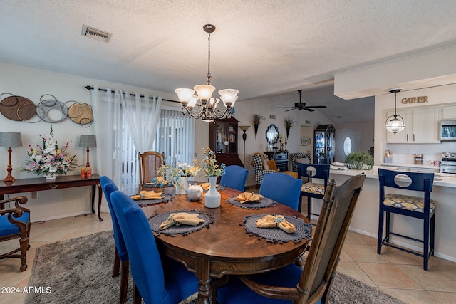 dining room featuring light tile patterned floors, vaulted ceiling, and a healthy amount of sunlight