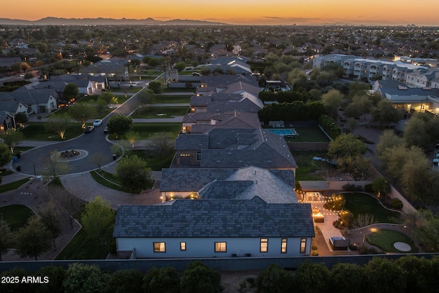 aerial view at dusk with a mountain view and a residential view