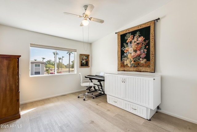 office area featuring baseboards, wood finished floors, and a ceiling fan