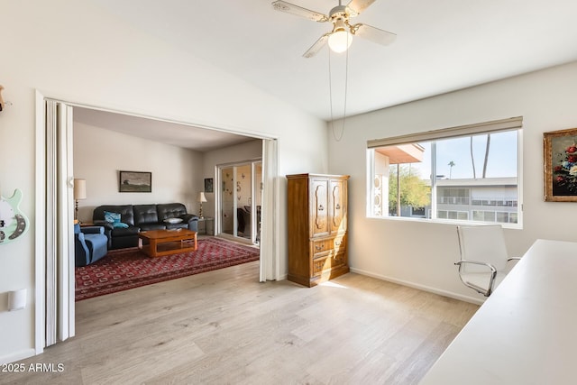 office space featuring lofted ceiling, light wood-style floors, baseboards, and ceiling fan