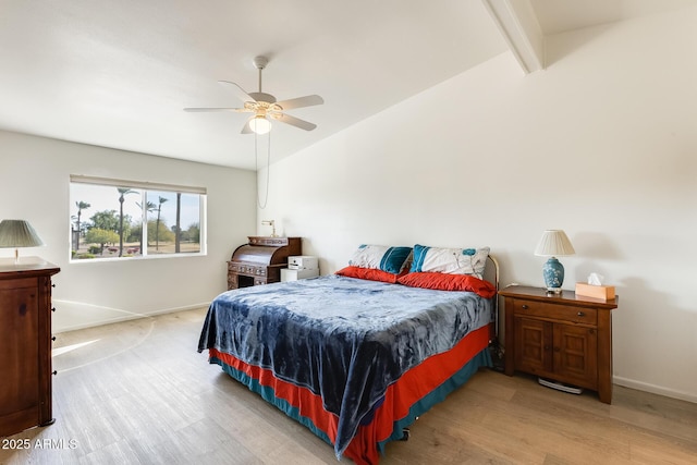 bedroom with vaulted ceiling with beams, a ceiling fan, baseboards, and wood finished floors