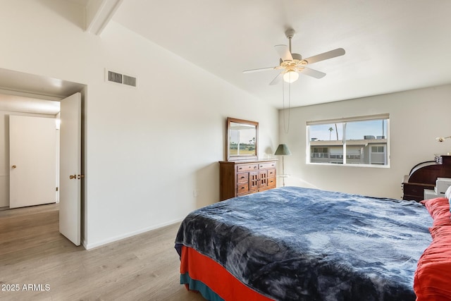 bedroom featuring visible vents, vaulted ceiling with beams, baseboards, light wood-type flooring, and a ceiling fan