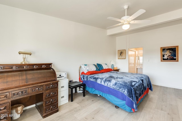 bedroom featuring ensuite bath, beam ceiling, light wood-style flooring, and ceiling fan