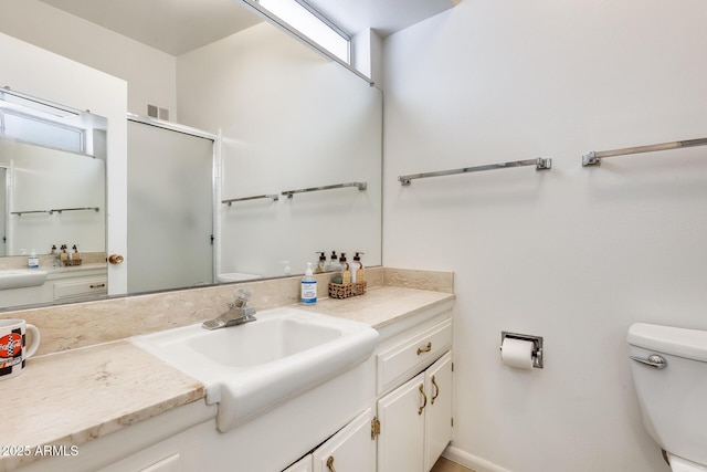 bathroom with a shower with door, visible vents, toilet, and vanity