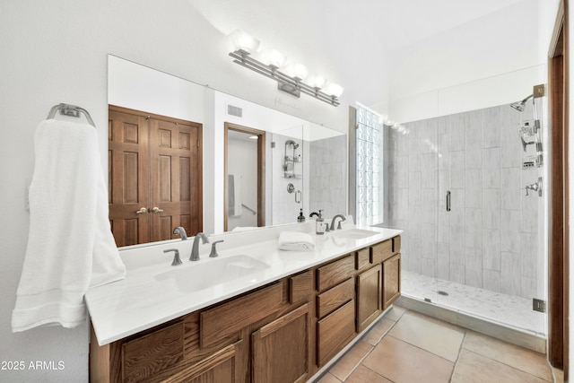 bathroom featuring vanity, a shower with shower door, and tile patterned flooring