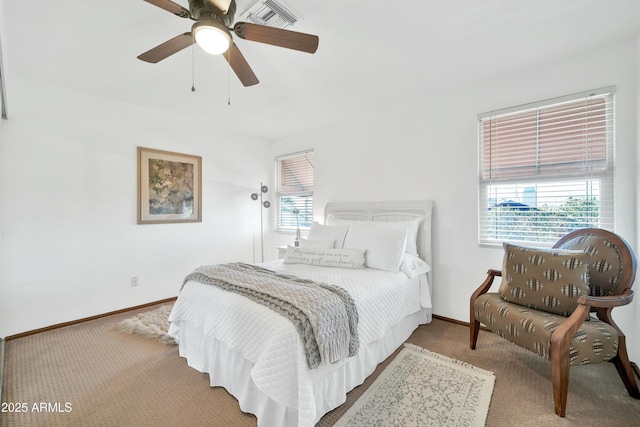 carpeted bedroom featuring ceiling fan and multiple windows