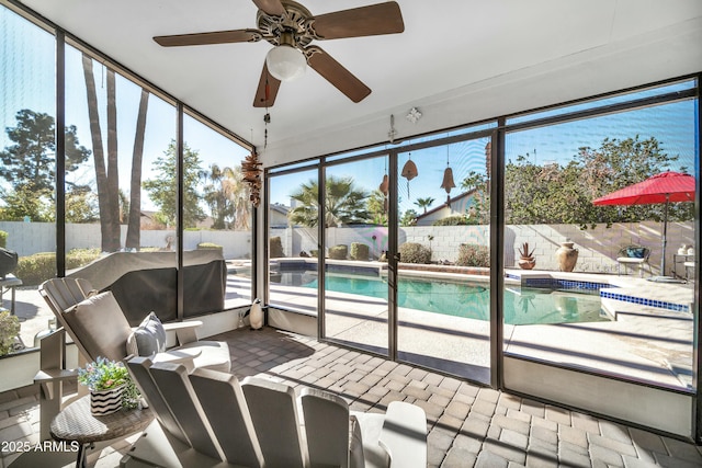 sunroom featuring ceiling fan