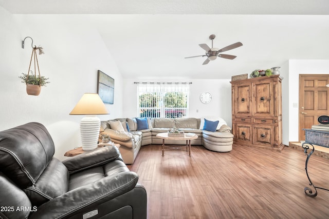 living room featuring ceiling fan, hardwood / wood-style flooring, and lofted ceiling