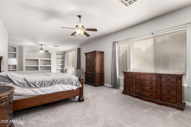 bedroom featuring light colored carpet, ceiling fan, and baseboards