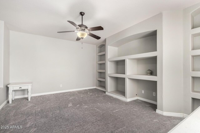 unfurnished living room with carpet floors, built in features, ceiling fan, and baseboards