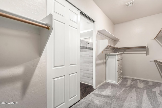 walk in closet with carpet flooring