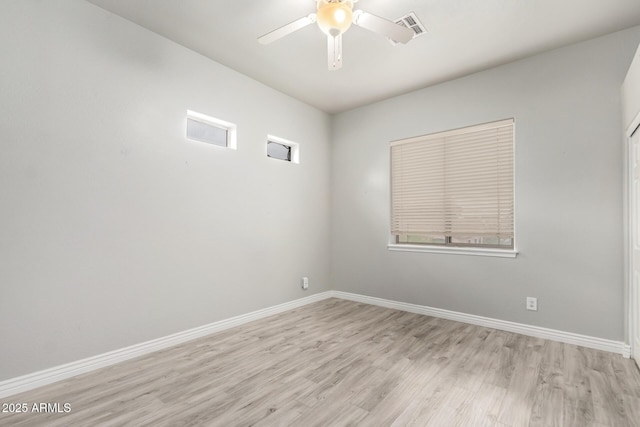 unfurnished room with light wood-style floors, ceiling fan, and baseboards