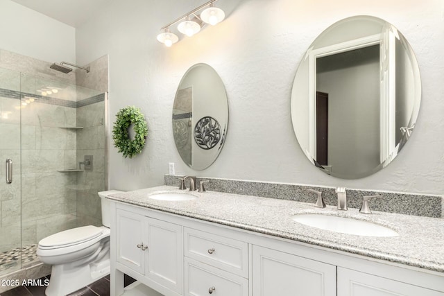 full bath featuring a shower stall, toilet, and double vanity