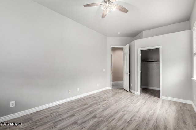 unfurnished bedroom with wood finished floors, baseboards, a closet, and ceiling fan