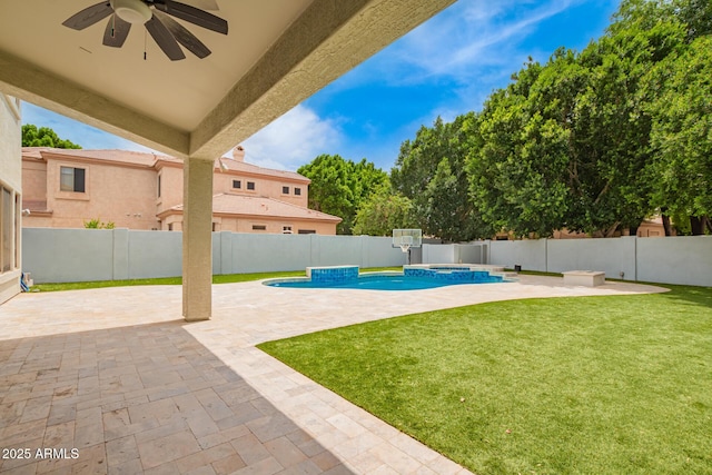 view of patio featuring ceiling fan and a pool with connected hot tub