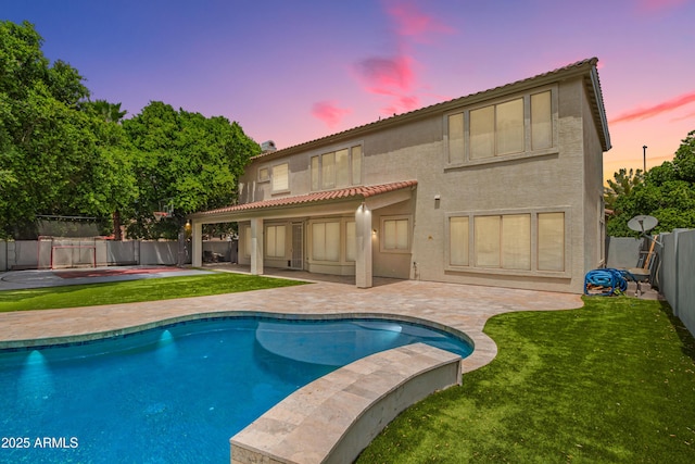 back of property with a patio, stucco siding, and a tiled roof