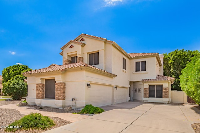 mediterranean / spanish-style home with stone siding, a tiled roof, a garage, stucco siding, and concrete driveway