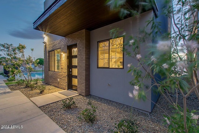 view of exterior entry at dusk