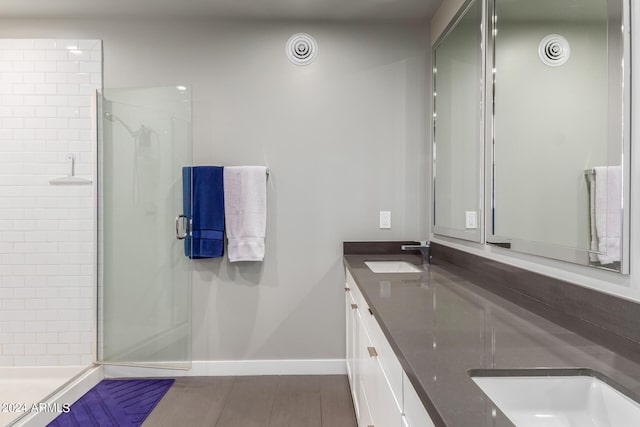 bathroom featuring a shower with door, vanity, and hardwood / wood-style flooring