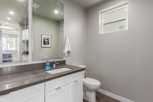 bathroom featuring tile patterned flooring, vanity, and toilet