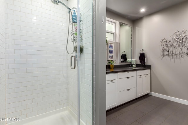 bathroom featuring tile patterned flooring, vanity, and an enclosed shower