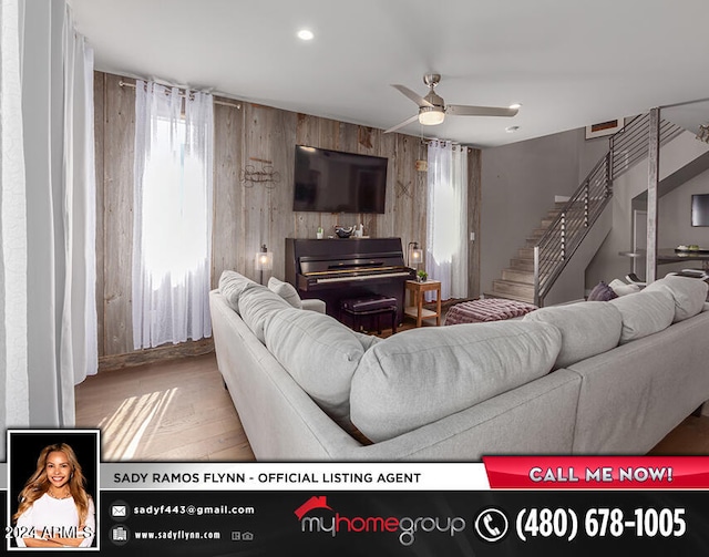 living room with ceiling fan and light wood-type flooring