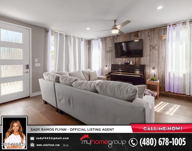 living room with light hardwood / wood-style flooring and ceiling fan