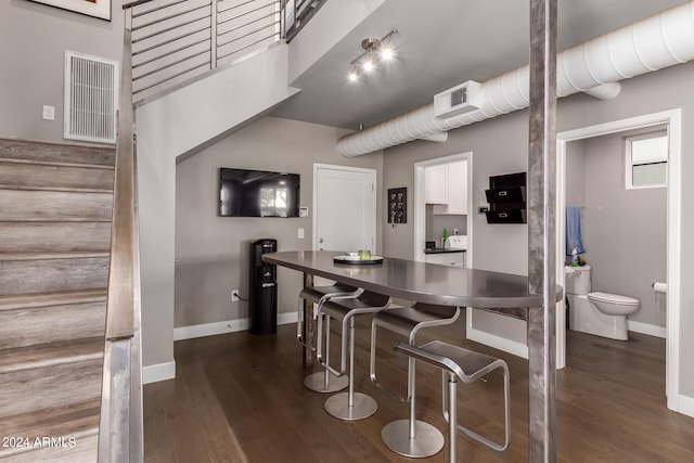 kitchen with dark wood-type flooring and white cabinets