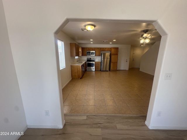 kitchen with ceiling fan, stainless steel appliances, and sink