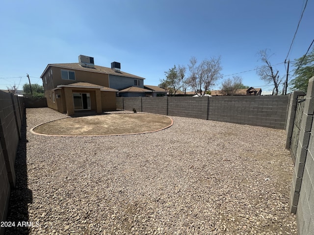 view of yard with cooling unit and a patio area