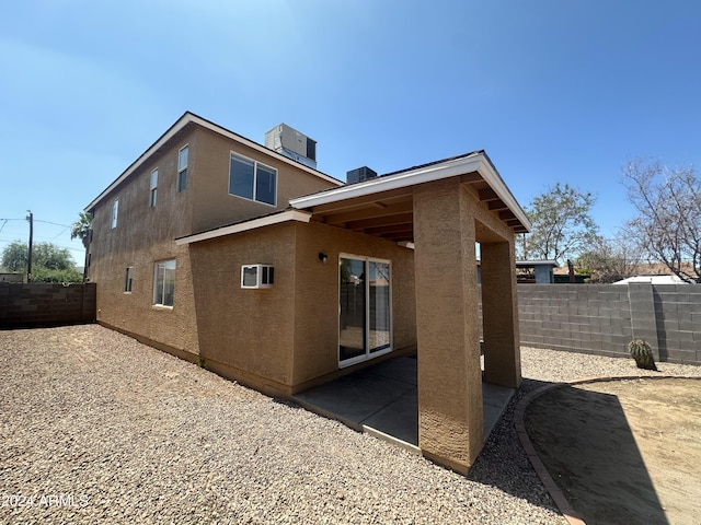 back of house featuring cooling unit and a patio area