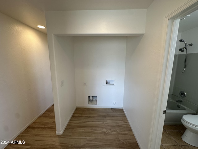 laundry area with wood-type flooring and hookup for a washing machine