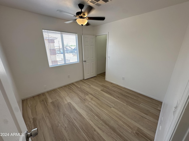 unfurnished bedroom featuring ceiling fan and light wood-type flooring