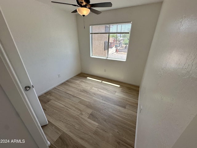 unfurnished room with ceiling fan and light wood-type flooring