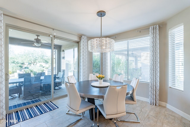 dining area featuring a healthy amount of sunlight and ceiling fan with notable chandelier