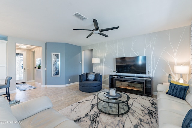 living room featuring light wood-type flooring and ceiling fan