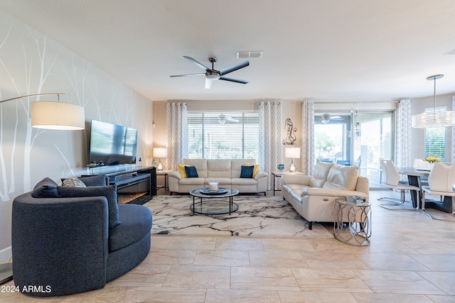 living room featuring ceiling fan and a wealth of natural light