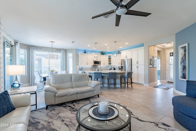 living room featuring light hardwood / wood-style floors and ceiling fan