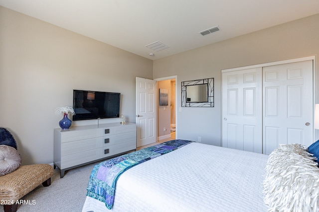 bedroom featuring carpet and a closet