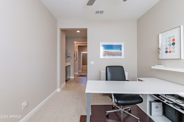 office space with ceiling fan and light colored carpet