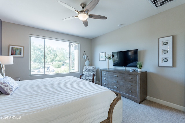 bedroom with ceiling fan and light colored carpet