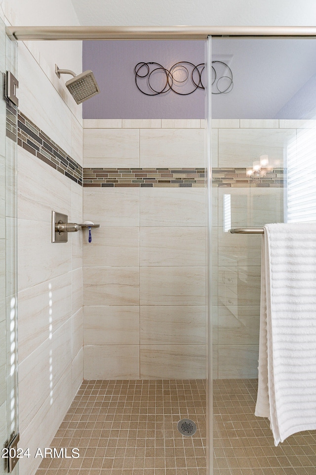 bathroom with a shower with shower door