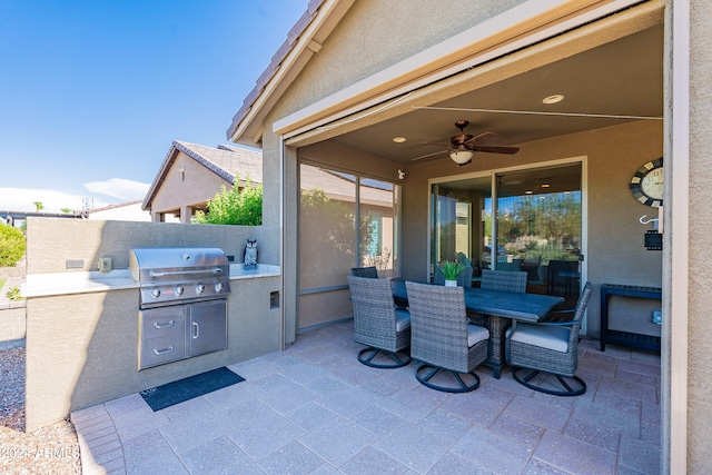 view of patio with ceiling fan, grilling area, and an outdoor kitchen