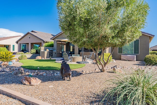 view of front of home featuring a front lawn, an outdoor living space, ceiling fan, and a patio area