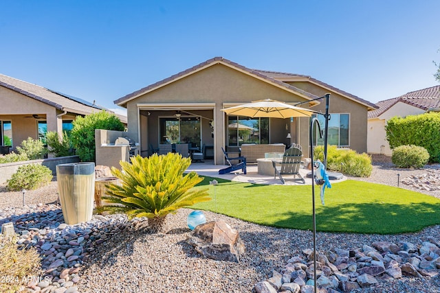 back of house with a lawn, a patio, an outdoor living space, area for grilling, and ceiling fan