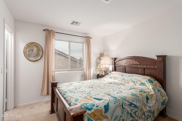 bedroom featuring visible vents, light carpet, and baseboards