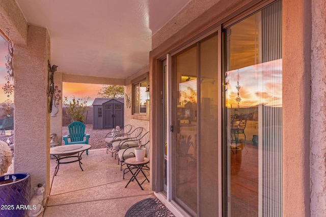 view of patio / terrace with a storage unit and an outbuilding