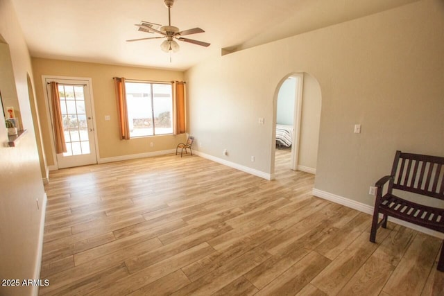 empty room with ceiling fan and light hardwood / wood-style floors