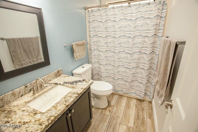 bathroom with vanity, toilet, and a shower with shower curtain