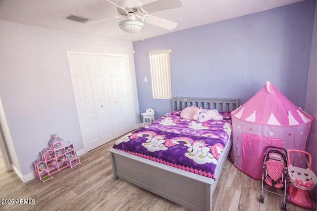 bedroom featuring hardwood / wood-style flooring, a closet, and ceiling fan